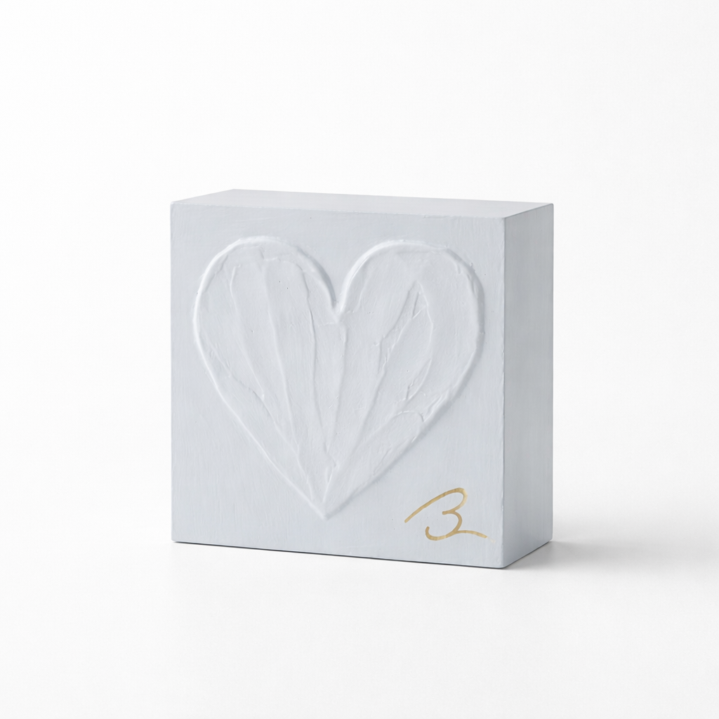 Blue Haze heart sculpture — textured heart detail showing layered cool blue brushstrokes signed in gold