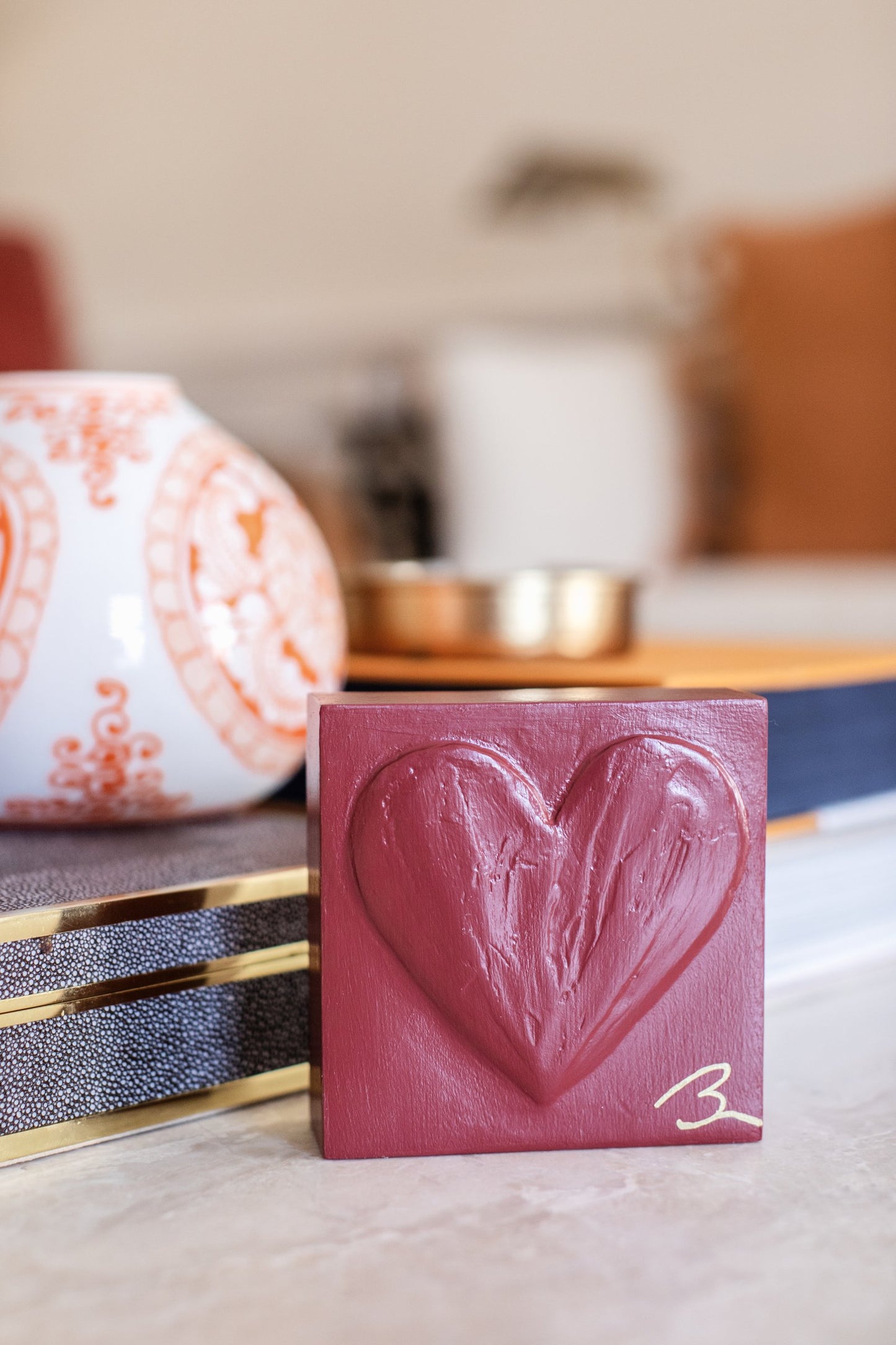 Cinematic Red hand sculpted heart — lifestyle setting showing dramatic red tone against neutral backdrop