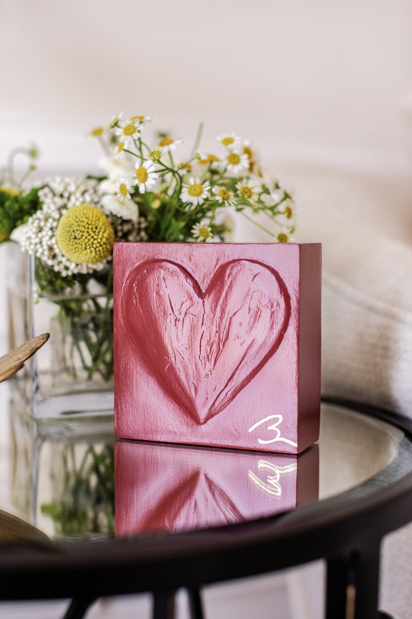 Cinematic Red heart sculpture — rich red textured heart detail with gold artist signature