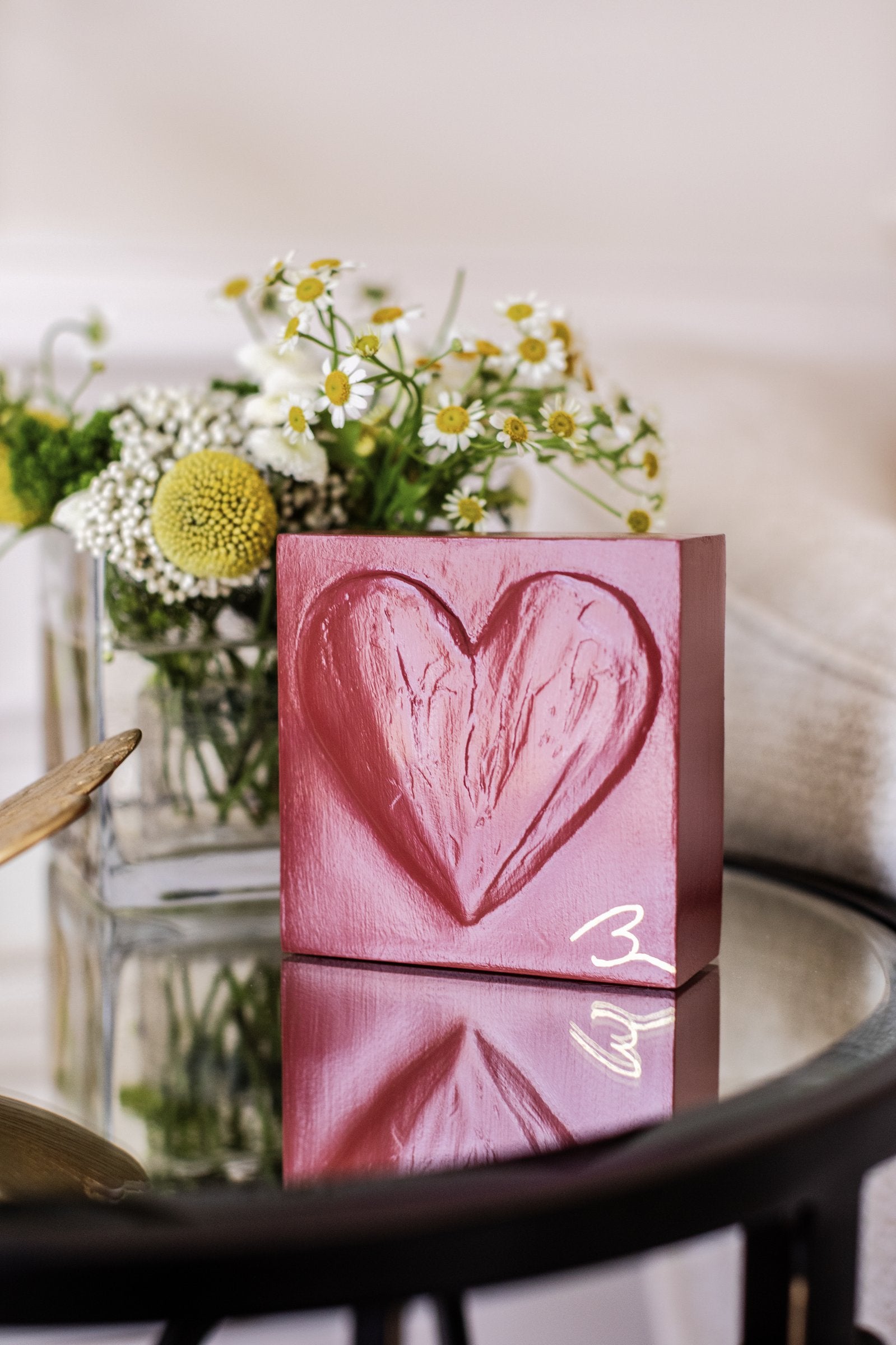Cinematic Red wood heart block — angled view showing layered brushstroke texture in deep crimson