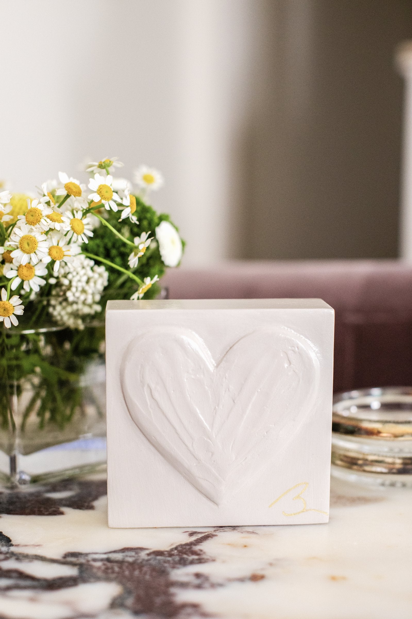 Delicate Pink hand sculpted heart — lifestyle setting showing soft pink tone on styled shelf