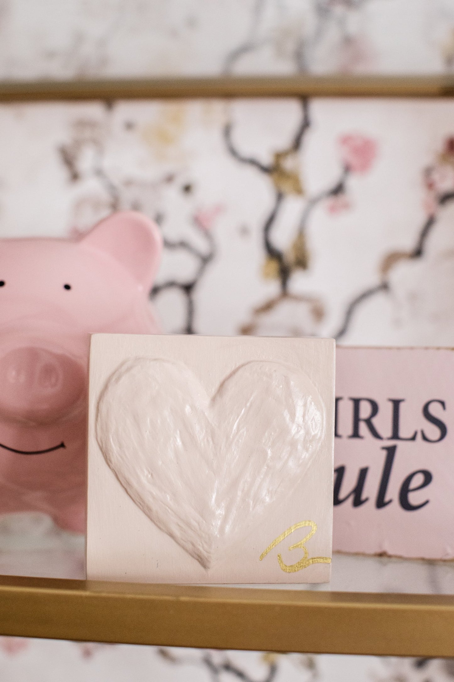 Faded Mushroom hand painted heart block in blush pink on styled shelf with gold accents