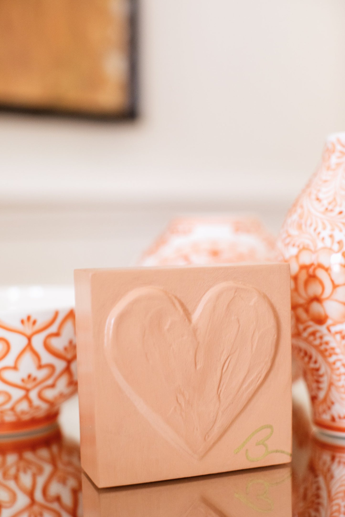 Muted Terracotta wood heart sculpture detail showing layered impasto texture