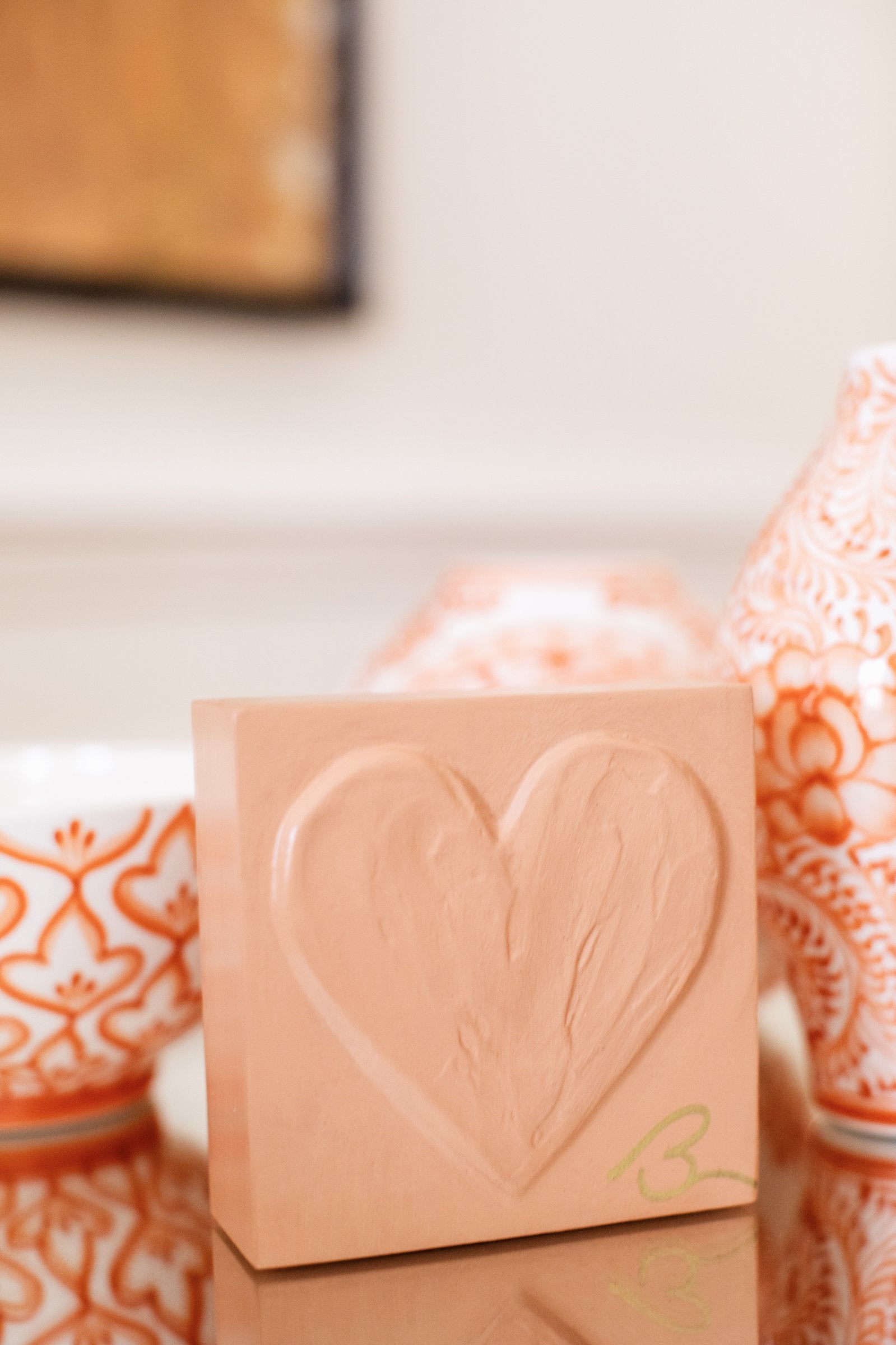 Muted Terracotta wood heart sculpture detail showing layered impasto texture